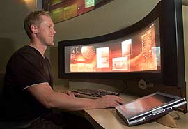 Thomas Gruver demonstrates a prototype work station in the new Microsoft Center for Information Work